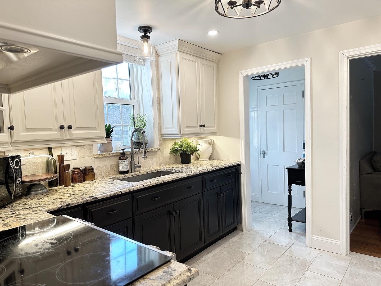 Renovated kitchen from the sink side with a doorway to the hall
